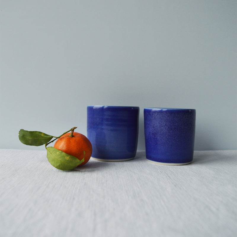 Porcelaine artisanale fabriquée en France, tasses à café bleues Maison Primavera sur fond blanc.