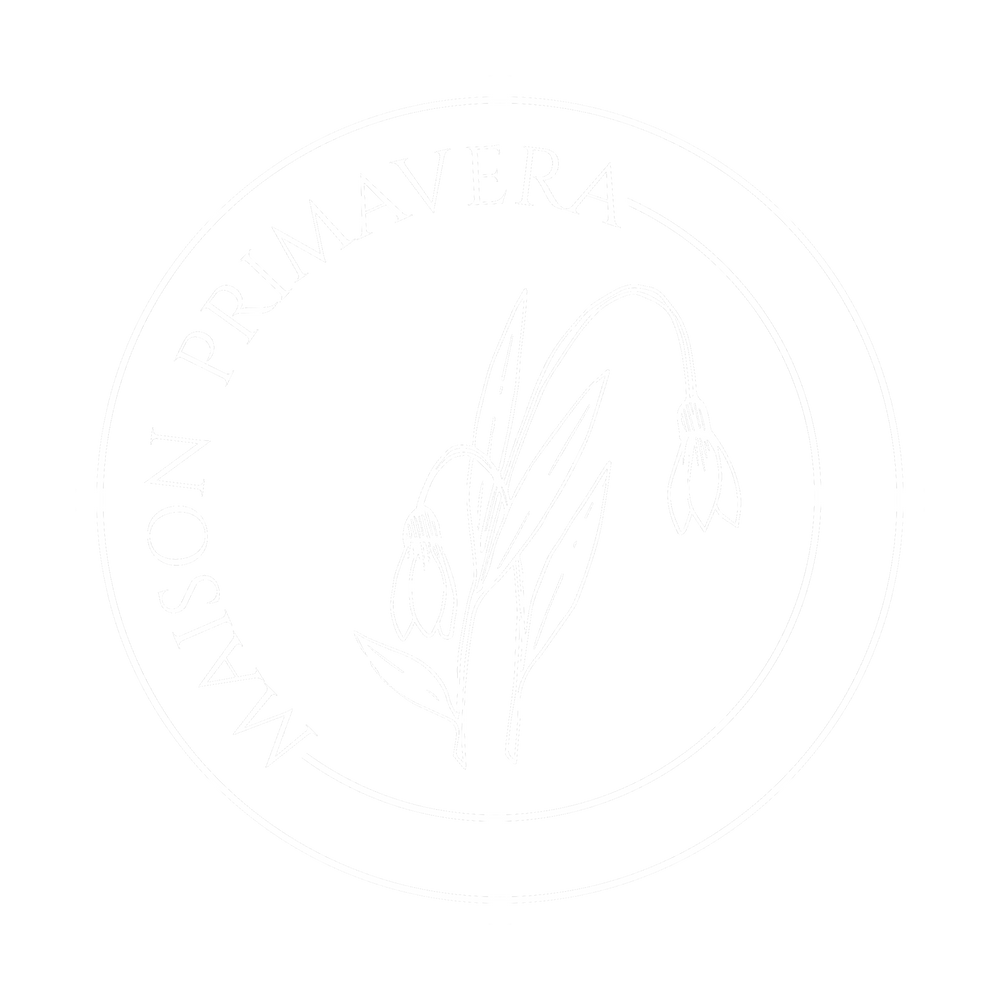 Logo Maison Primavera deux perce-neige entremêlés dans un cercle