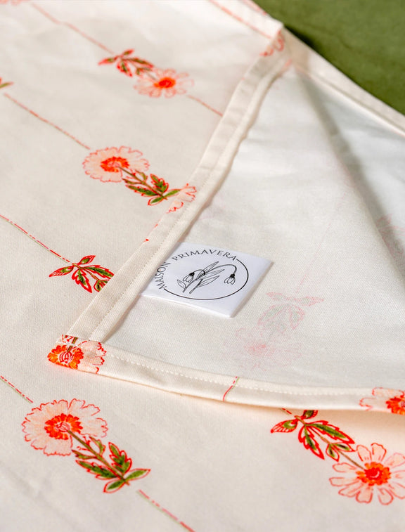 Zoom sur une nappe fabriquée en France avec un motif de rayures et de fleurs des champs