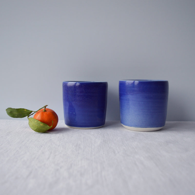 Porcelaine artisanale fabriquée en France, tasses à thé bleues Maison Primavera sur fond blanc.