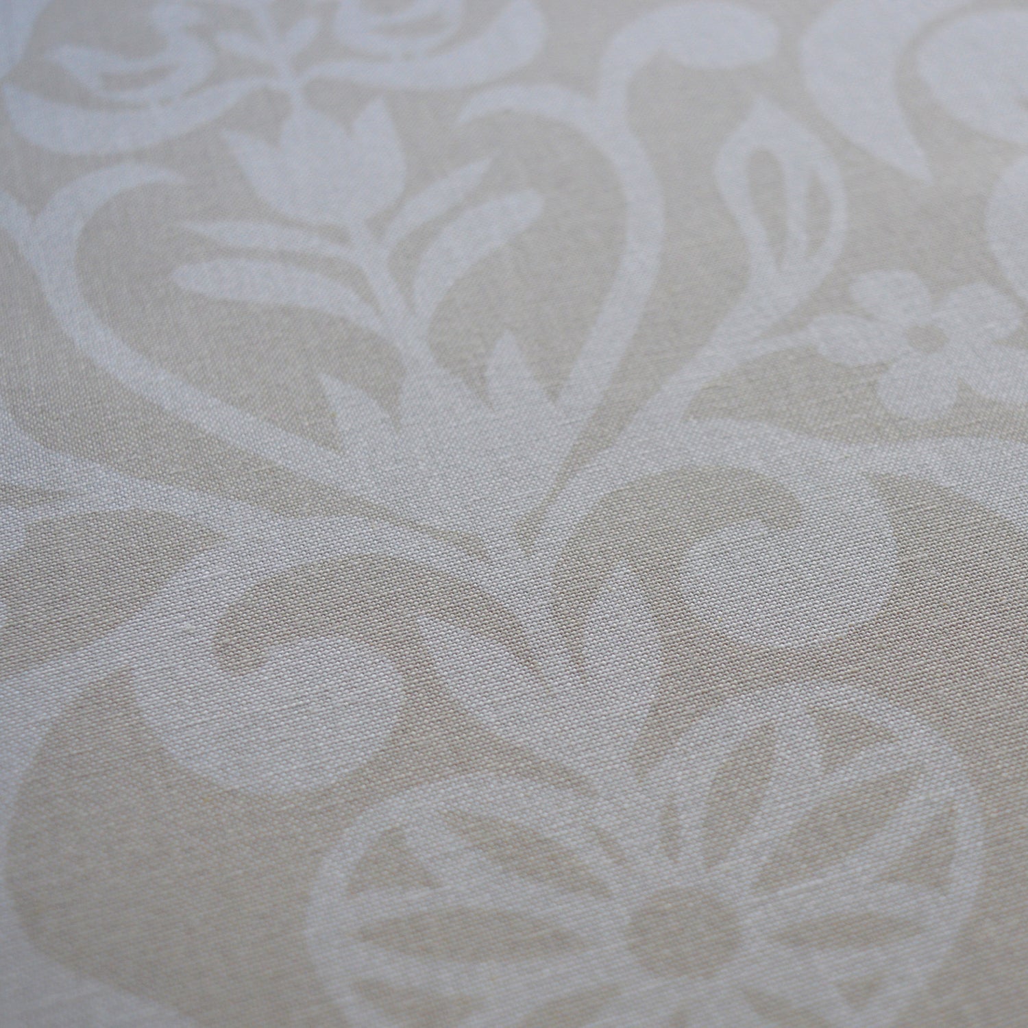 Zoom sur tissu en coton et en lin fabriqué en France dans les Vosges, motif arbre de vie alsacien, blanc sur fond beige